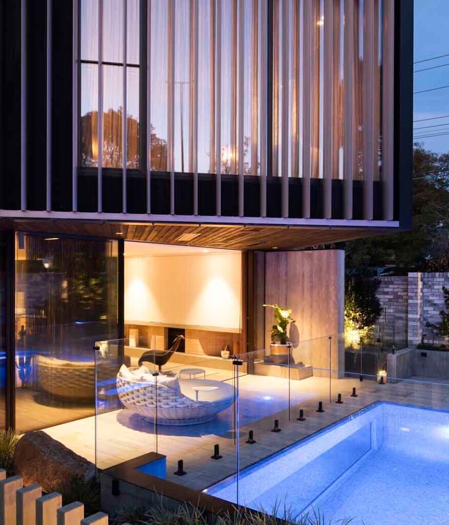 Brighton Residence poolside exterior at dusk by PJ Thomas Homes